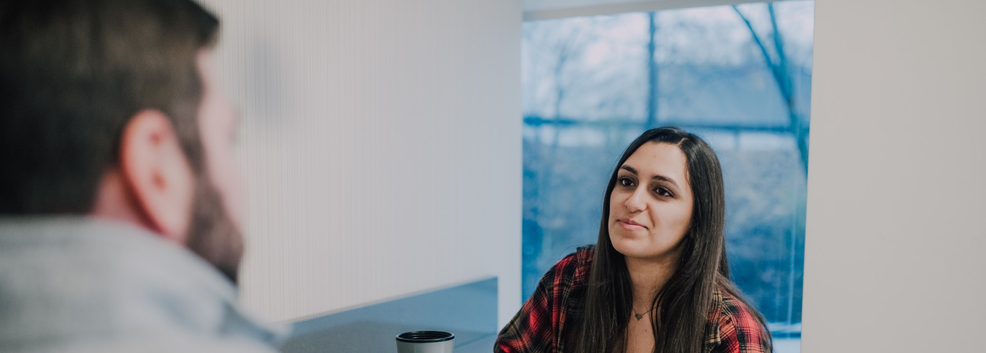 woman facing the camera sitting down with a consoler