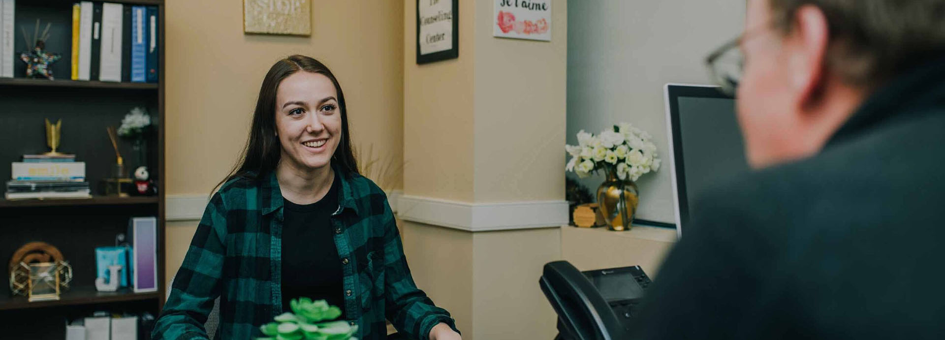 woman facing the camera smiling talking to a consoler 