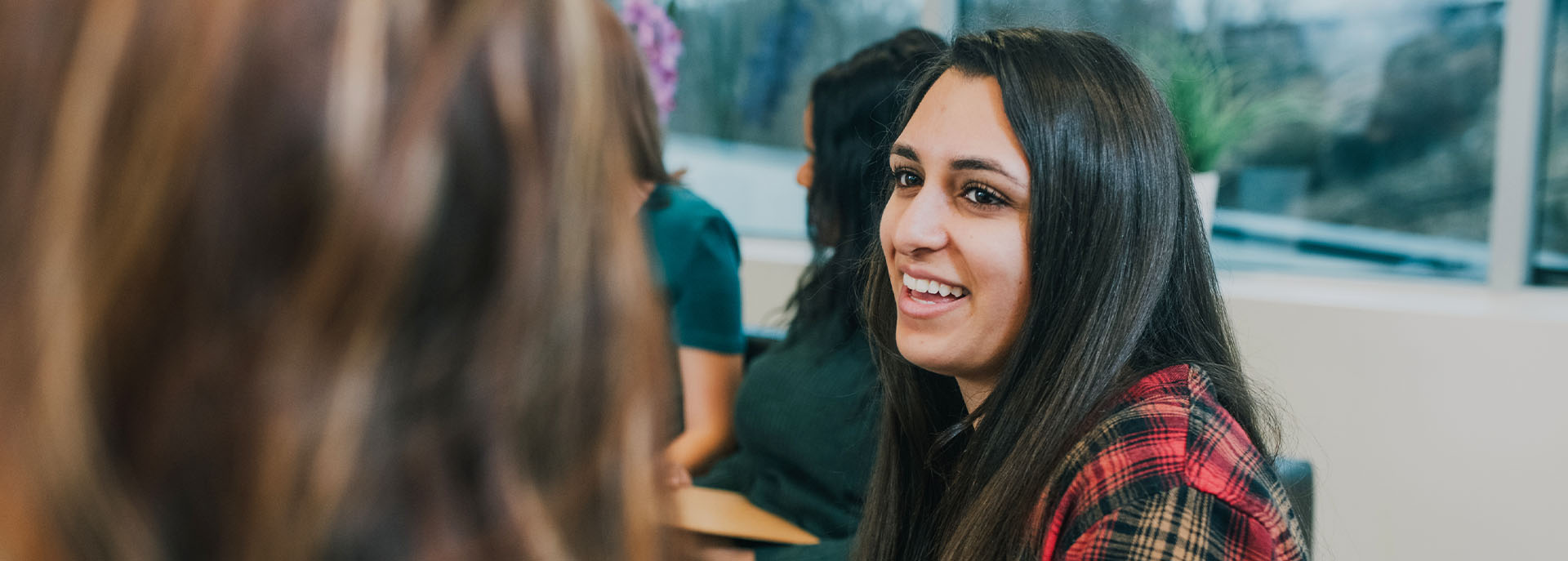 woman looking at another woman laughing