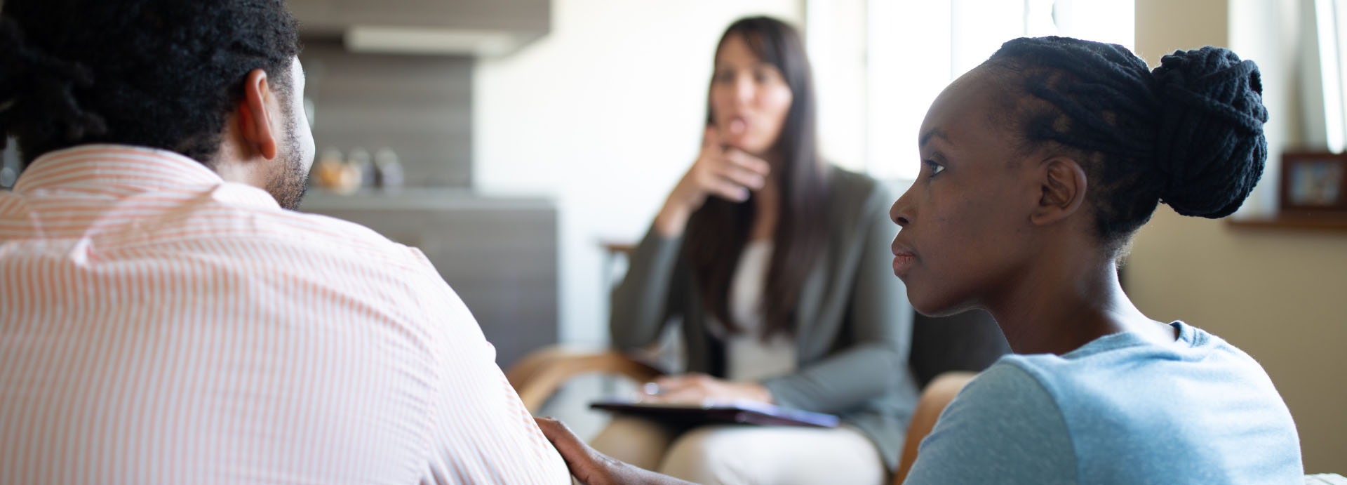 woman looking at man sitting at therapy session